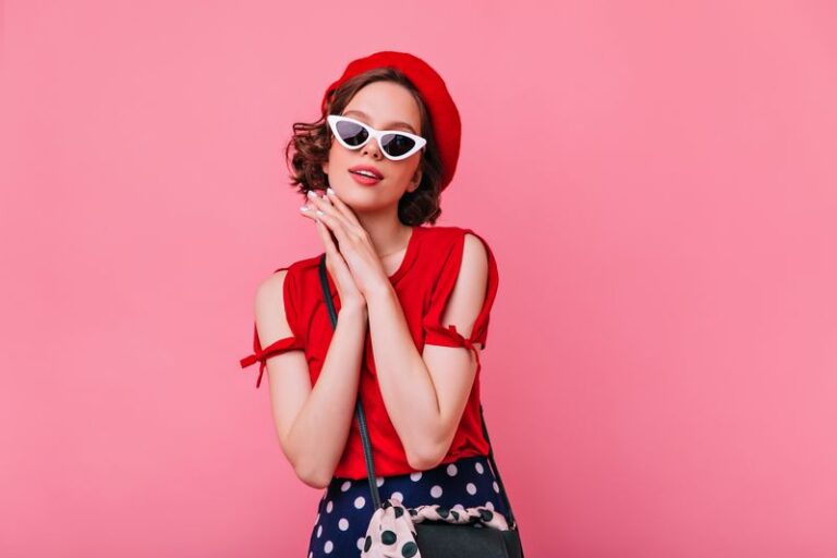 Graceful pale girl in french beret standing on pastel background